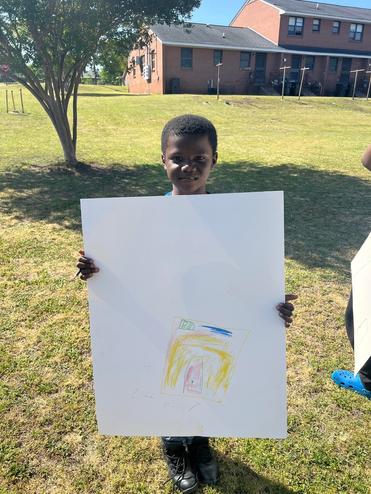 Little Boy showing off his What Home Means to Me poster