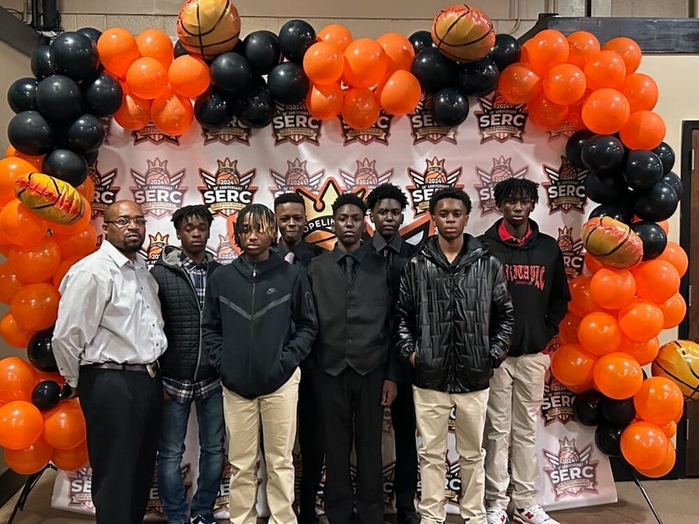 hacg hornets boys basketball team in front of step and repeat.jpg